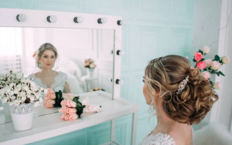 Bride deciding between multiple elegant long hair wedding hairstyles