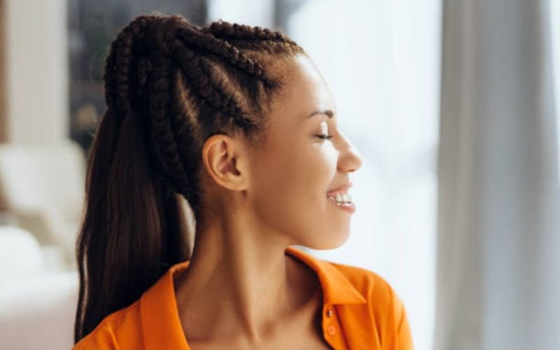 Elegant Black woman wearing a low ponytail hairstyle.