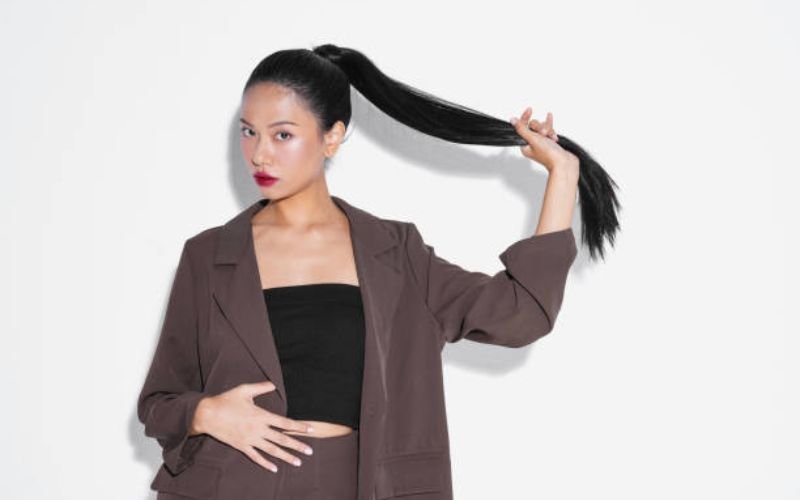 Black woman with sleek straight ponytail hairstyle.