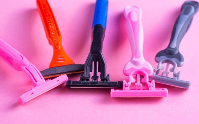 Top 5 razors for shaving head displayed on a counter
