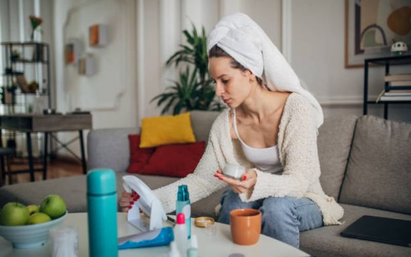 woman reading hair care guide with notebook and hair products